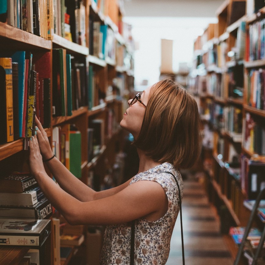 woman in library representing the search for minority authors