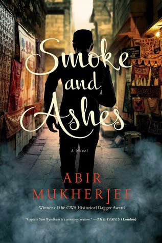 Book cover of Smoke and Ashes by Abir Mukherjee shows the silhouette of a man walking down an Indian street. Historical crime novel. 