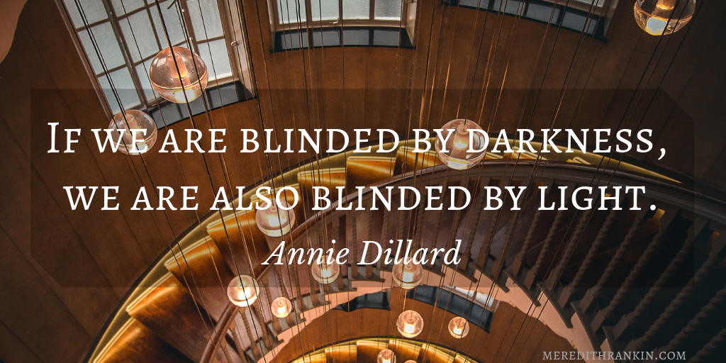 Quote from Annie Dillard reads, "If we are blinded by darkness, we are also blinded by light." Background shows a curved staircase, bare lightbulbs dangling in the center, and a windowed wall, all from an above angle.