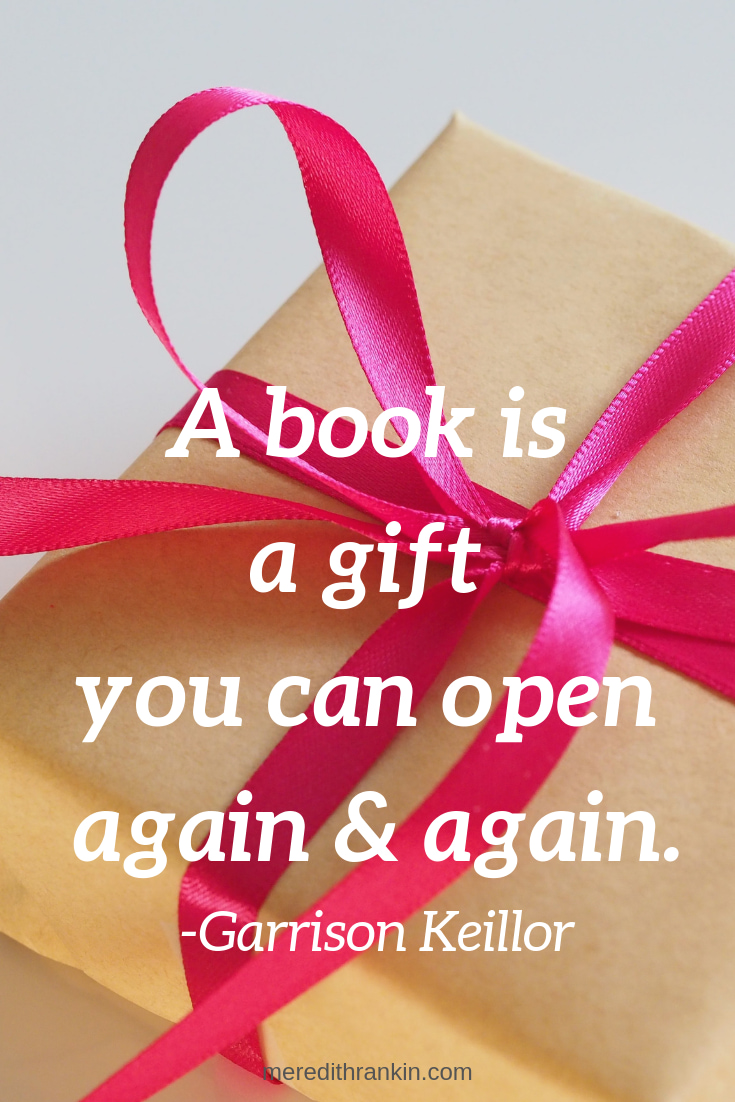 Quote by Garrison Keillor reads, "A book is a gift you can open again and again." Background shows box wrapped with bright pink ribbon.